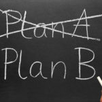 Crossing out Plan A and writing Plan B on a blackboard. Crossing out Plan A and writing Plan B on a blackboard.